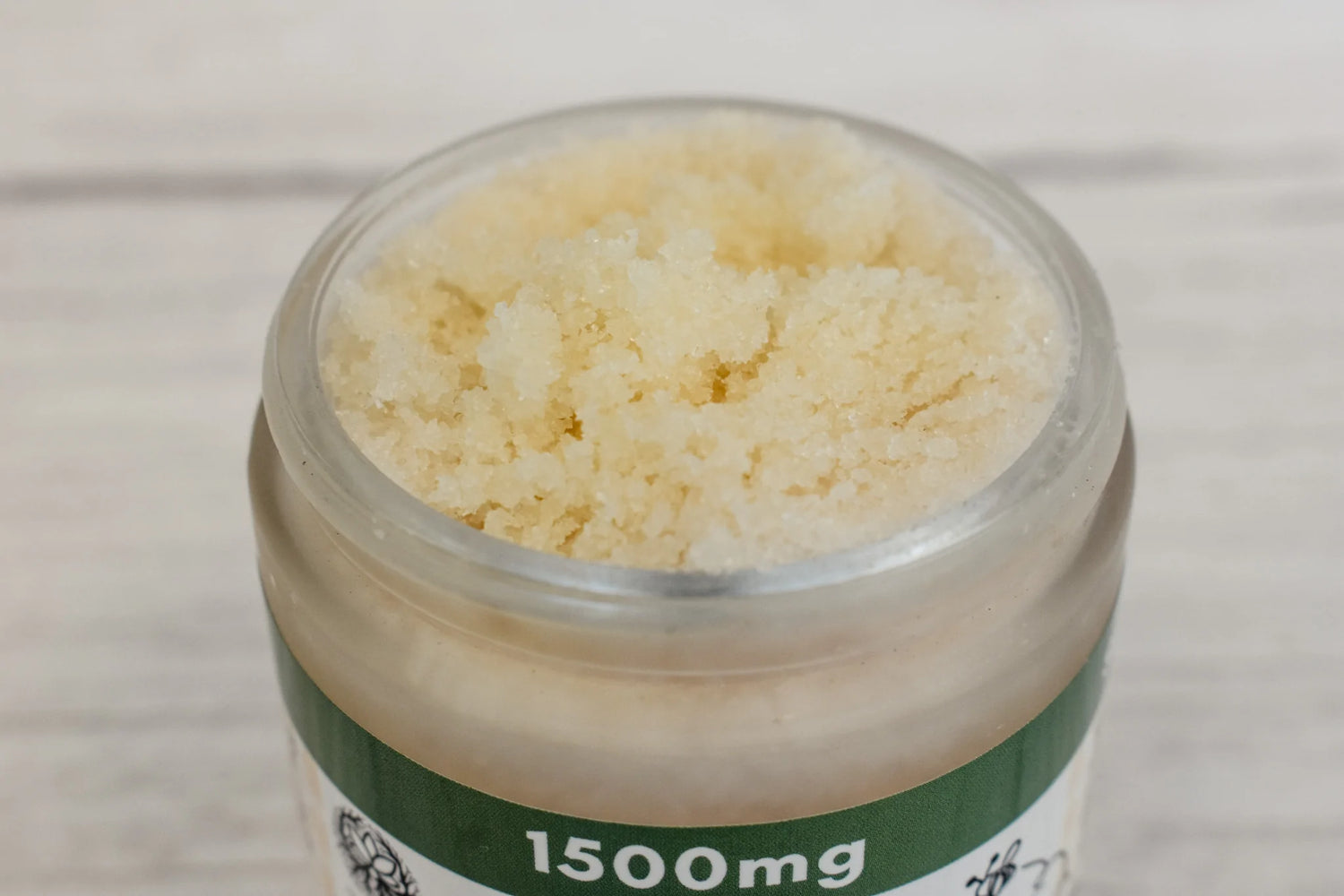 an open bottle of CBD sea salt body scrub
