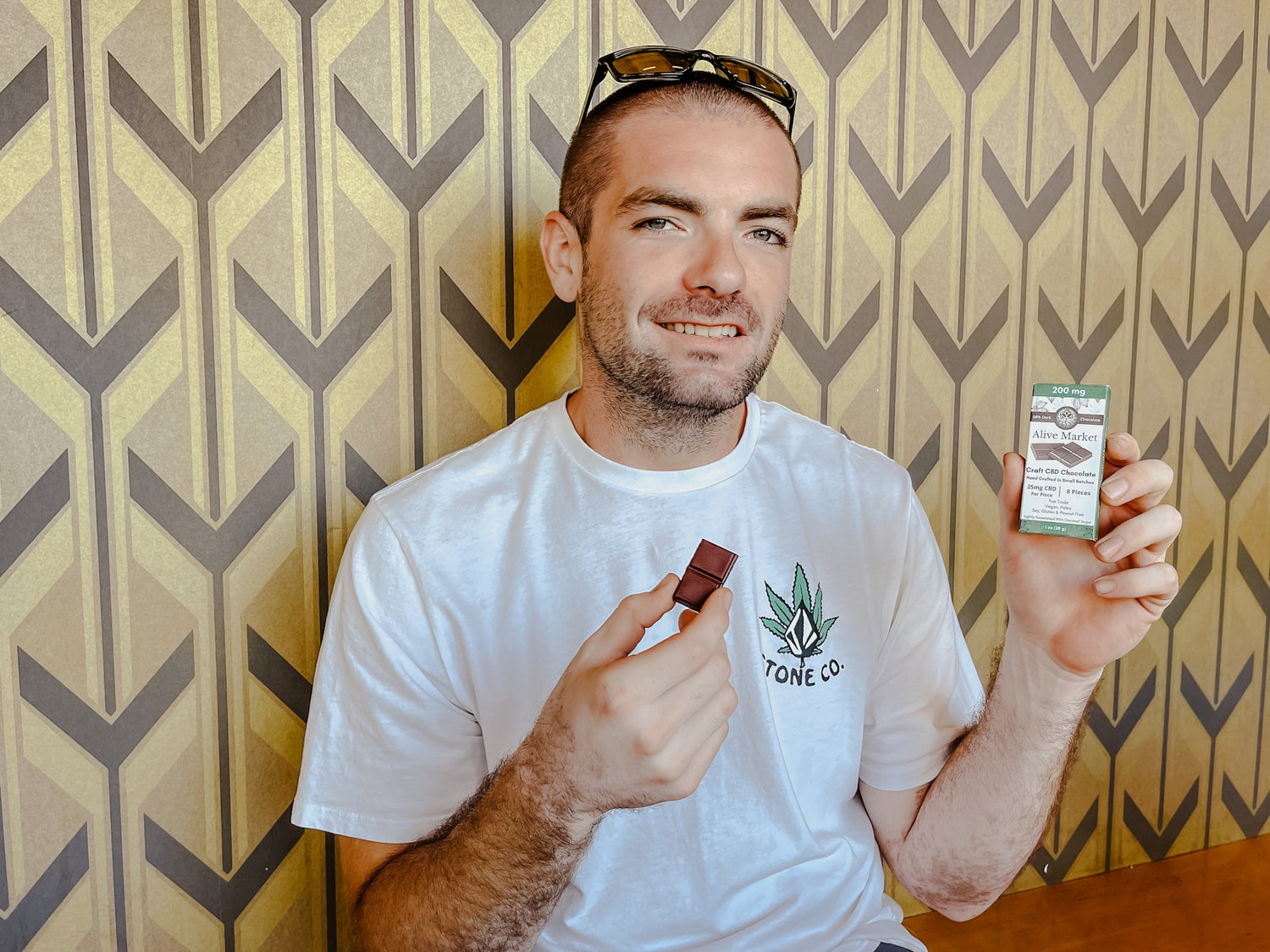 A man holding a bar of CBD chocolate