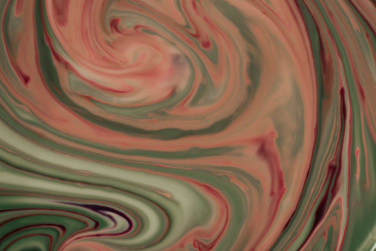 an abstract marbling image of orange and green.